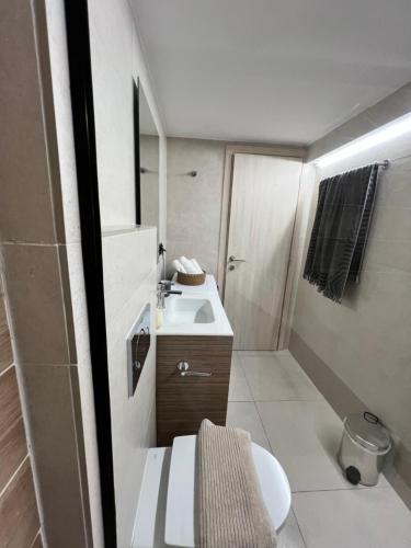 a small bathroom with a sink and a toilet at Olea White in Skiathos Town
