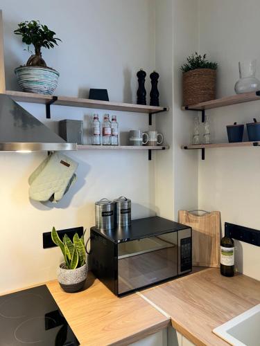 a kitchen with a black microwave on a counter at Olea White in Skiathos Town