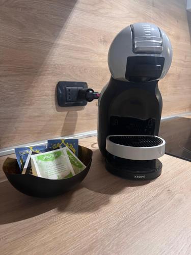 a coffee maker sitting next to a bowl of food at Grazioso appartamento in Aosta