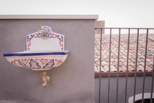 a bathroom sink on the side of a wall at Dimora De Mauro in Catania