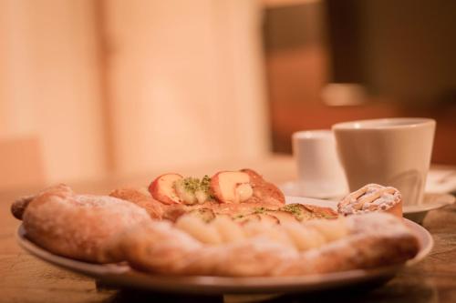 a plate of food with bread and a cup of coffee at Dimora De Mauro in Catania