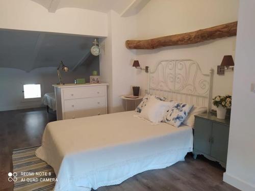 1 dormitorio con 1 cama blanca grande y vestidor en Casa Rural Rafaela 