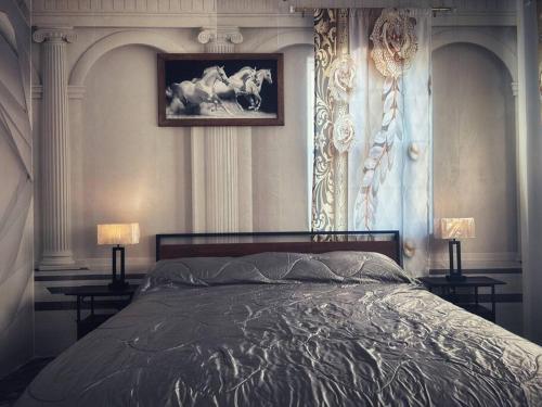 a bedroom with a bed with two lamps and a picture at Luxury Palace / Vacation Home in Alvin