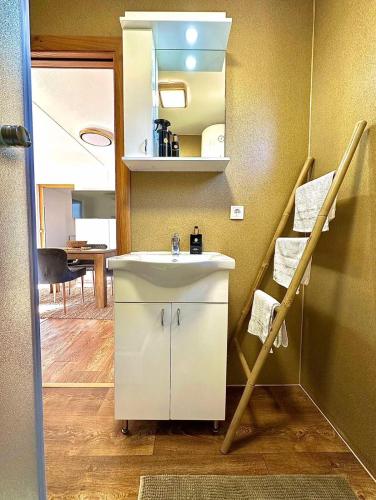 a bathroom with a white sink and a staircase at Aqua Vita Concept in Bihać
