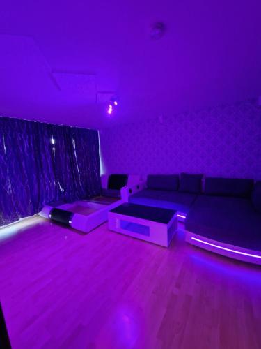 a living room with purple lighting and a couch at Apartment Darmstadt Mitte in Darmstadt