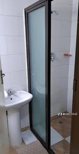 a bathroom with a sink and a glass shower at 11036 in Ndola