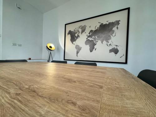 a large wooden table in a room with a map on the wall at Fiorini - Rooms in Rome