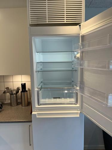 een lege koelkast met de deur open in een keuken bij Casa House of Bricks 2 - LEGOLAND 650m in Billund