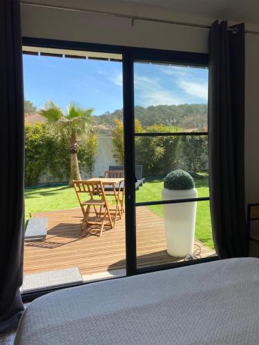 a bedroom with a sliding glass door looking out onto a deck at Chambre d’hôte indépendante in Lacanau