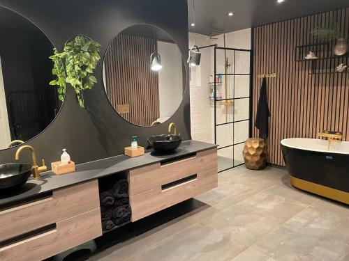 a bathroom with two sinks and a tub and a mirror at Exclusive view villa in Tromsø