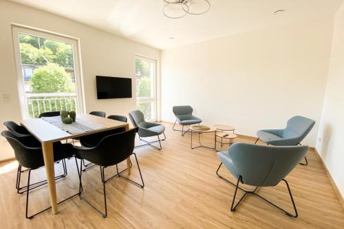a room with a table and chairs and a tv at 110 Lux Furnished flat in Beaufort