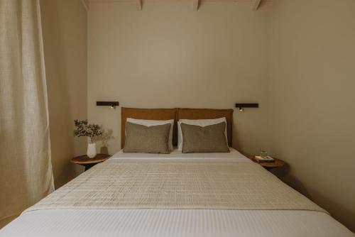 a bedroom with a large bed with two pillows at Sophisticated Preveza Villa Villa Harmony 2 Bedrooms Breathtaking Ionian Sea View And Private Pool Kanali Beach in Preveza