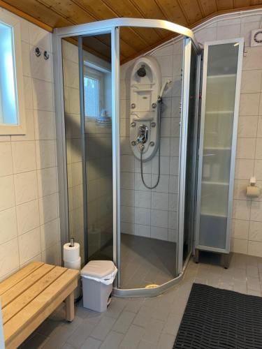y baño con ducha, aseo y banco. en Villa Skoganvarre, en Skoganvarre