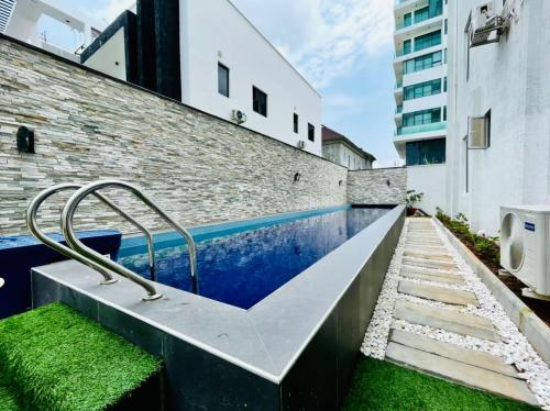 a swimming pool in the middle of a building at Rod Apartments in Lagos