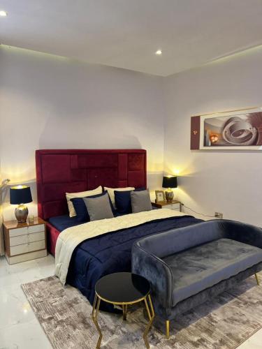 a large bedroom with a large bed and a table at Rod Apartments in Lagos