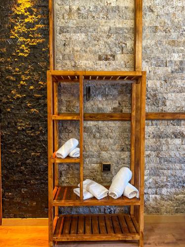 a wooden shelf with white pillows on it at Dayf Suit Naliya Otel in Çamlıhemşin