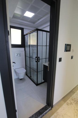 a bathroom with a toilet and a window at Marin Villaları Villa-2 in Marmaris