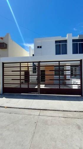 a building with its doors open on a street at House 5 min by the beach, with wide open garage. in Mazatlán