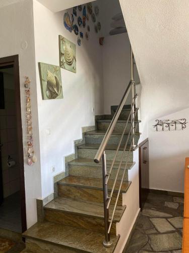 a staircase in a house with a stair railing at Βεράντα στο Αιγαίο in Kókkinon Nerón