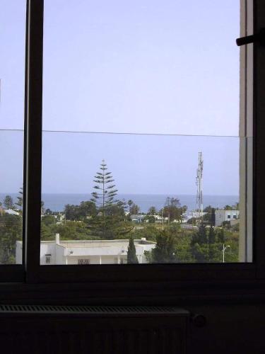 a window with a view of a building at Le lagon de Hammamet in Hammamet