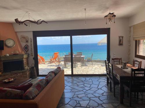 a living room with a view of the ocean at Βεράντα στο Αιγαίο in Kókkinon Nerón