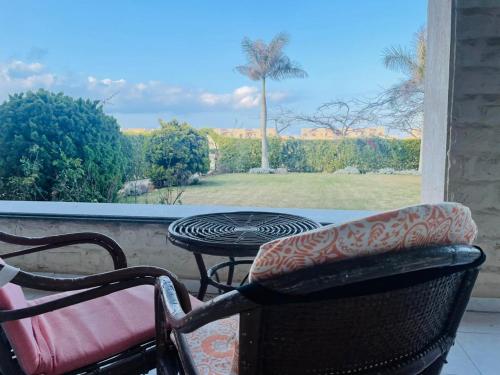d'une terrasse avec une table et des chaises et une vue sur un champ. dans l'établissement Hasna chalet, à El Alamein