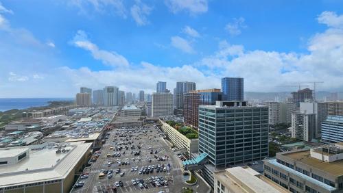 an aerial view of a busy city with cars at Luxury Ala Moana Resort 25th floor with balcony in Honolulu