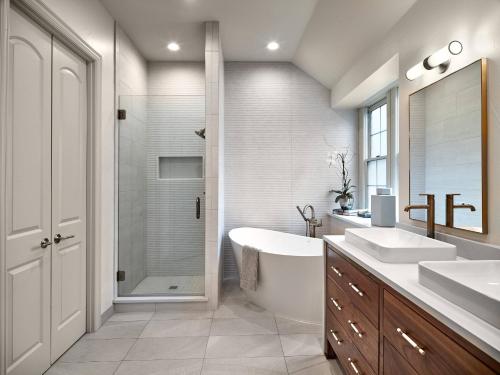 a bathroom with two sinks and a tub and a shower at Brown Villa in Edmonton
