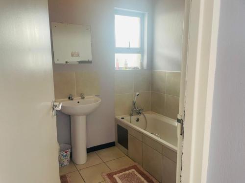 a bathroom with a sink and a bath tub at The Beacon Unit 32 in East London