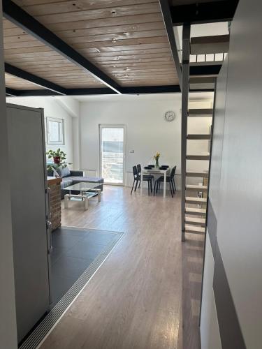 a living room and dining room with a spiral staircase at Apartment Štucin in Vipava