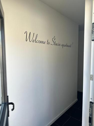a wall with a welcome to singapore sign on it at Apartment Štucin in Vipava