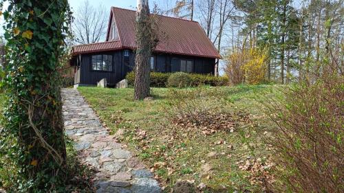 a house with a stone path in front of it at Domek wypoczynkowy Gowidlino in Gowidlino