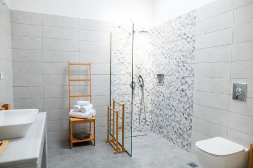 a bathroom with a shower and a toilet and a sink at Ki.Kos - Private House in Kos