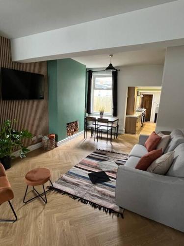 a living room with a couch and a table at Entire house in Liverpool in Litherland