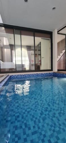 a large swimming pool in a building at Vincaza villa in Tlekung