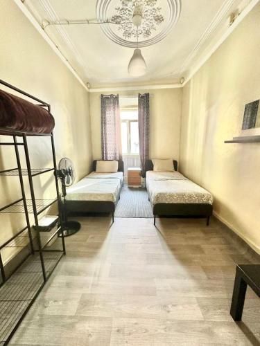 a room with three bunk beds and a chandelier at Sri-Indo Guest House in Lisbon
