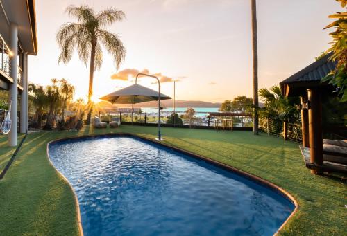 an image of a swimming pool at a resort at 'Sail Away' Airlie Beach house with Marina Views in Airlie Beach