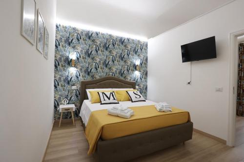 a bedroom with a bed and a wall mural at Maison Sara in Bari