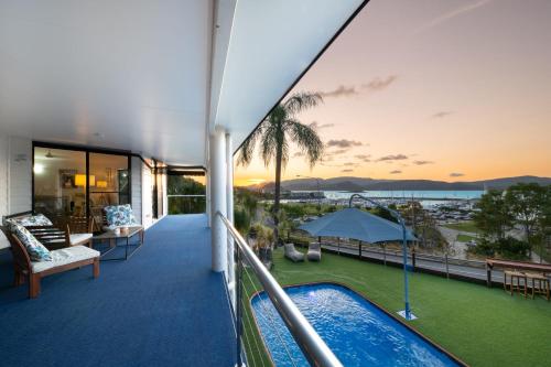 a view from the balcony of a house with a swimming pool at 'Sail Away' Airlie Beach house with Marina Views in Airlie Beach