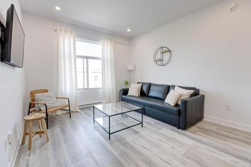 a living room with a couch and a table at Le Mile End by M11 - Neat & Spacious 1BDR Unit in Montréal
