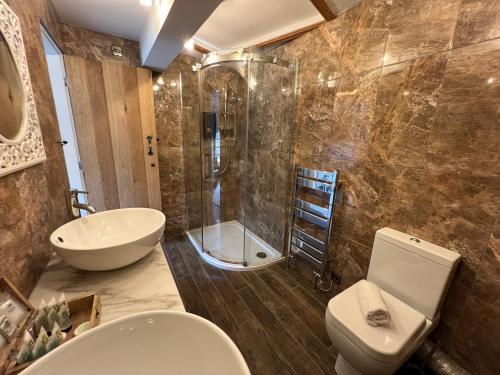 a bathroom with a sink and a toilet and a shower at The Bridge House Restaurant and Hotel in Alton