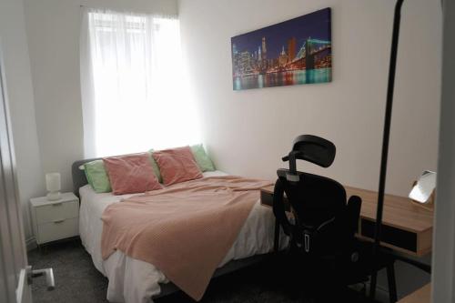 a bedroom with a bed and a desk and a window at Falkirk City Centre Stylish Two-Bedrooms Apartment in Falkirk