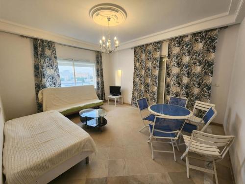 a living room with a bed and a table and chairs at Princesse de la mer in Douane
