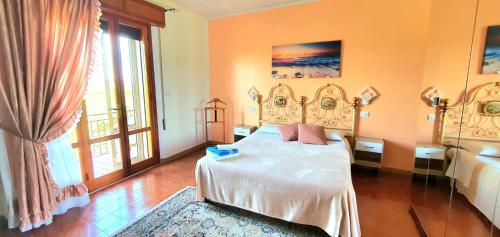 a bedroom with a bed and a large window at Villa Sartori in Legnago