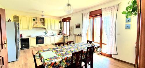 a kitchen with a table and chairs and a kitchen with a table and a kitchen at Villa Sartori in Legnago