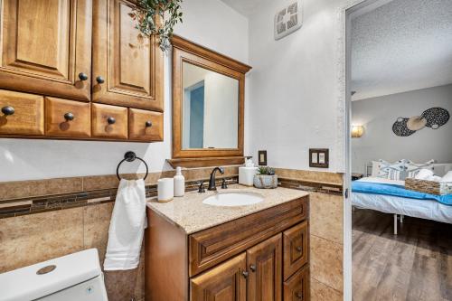 a bathroom with a sink and a mirror at Pet friendly Studio with Private Yard in Orlando