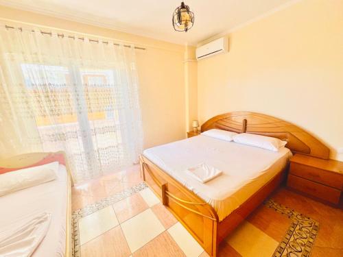 een slaapkamer met een bed en een raam bij N&E Apartment 1 in Durres, Beach. in Durrës