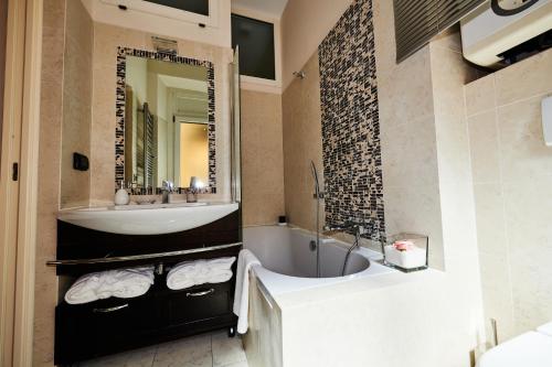 a bathroom with a tub and a sink and a bath tub at Vatican Prestige - Meospiti Cesare Exclusive in Rome