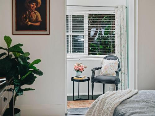 a bedroom with a chair and a window at XQ Collection Jaques la Maison in Sydney