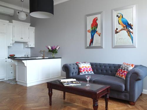 a living room with a blue couch and a table at Warsaw Concept in Warsaw